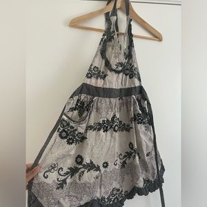 Halter apron. Ruffles and a button with a sweetheart neckline.